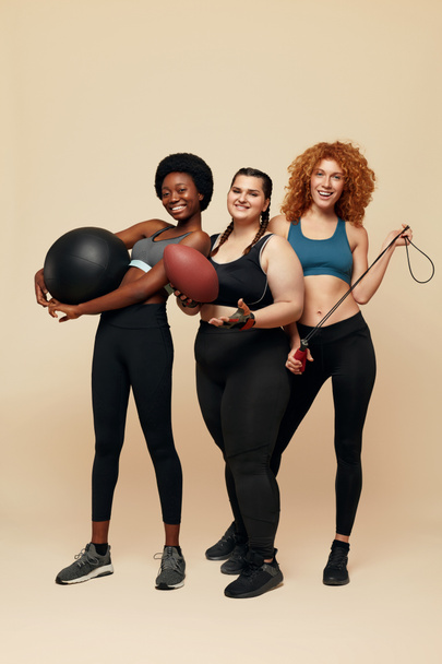 Diversity Models. Different Ethnicity And Size Women. Smiling Multicultural Friends In Sportswear Holding Fitness Equipment. Sport For Active Lifestyle. - Foto, Imagem