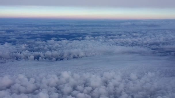 Amazing footage of aerial view above the clouds. View from the airplane window to the blue sky and white clouds. Flying over beautiful sky and clouds. Aerial view from the airplane. - Footage, Video