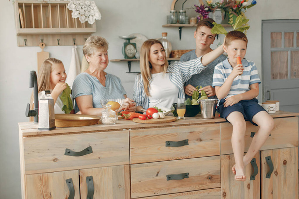 Beautiful big family prepare food in a kitchen - Fotografie, Obrázek