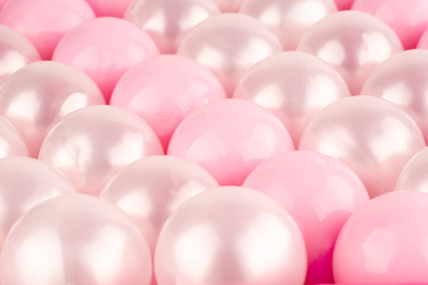 Pink and white plastic balls as a background. - Photo, image