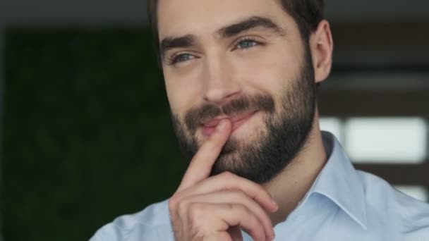 Handsome positive optimistic young business man indoors in office - Video