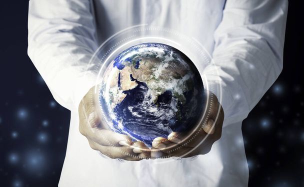 Businessman hand holding multinational hologram globe concept for world map responsibility, global education classroom online, CSR earth ecosystem Elements of this image furnished by NASA - Foto, imagen