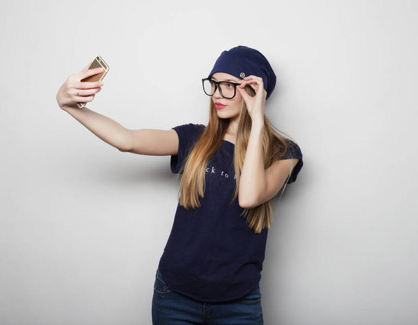 Pretty young woman taking selfie. - Valokuva, kuva