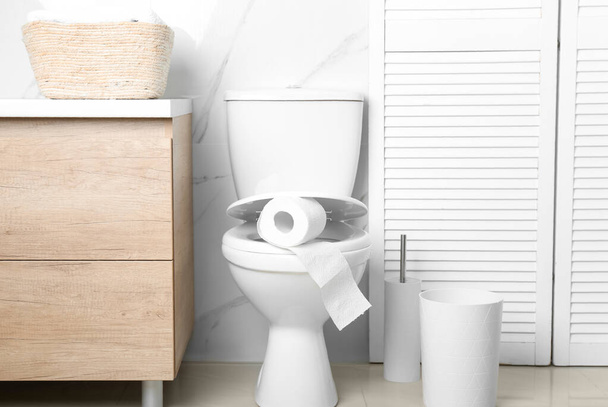 New paper roll on toilet seat in bathroom - Photo, Image