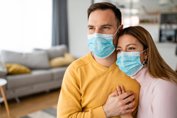 Pandemic coronavirus couple home isolation auto quarantine wearing face mask protective for spreading of disease virus - Photo, image
