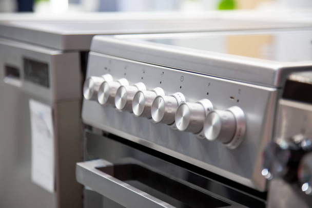 handles of a gas or electric stove, close-up, side view, soft focus - Photo, Image
