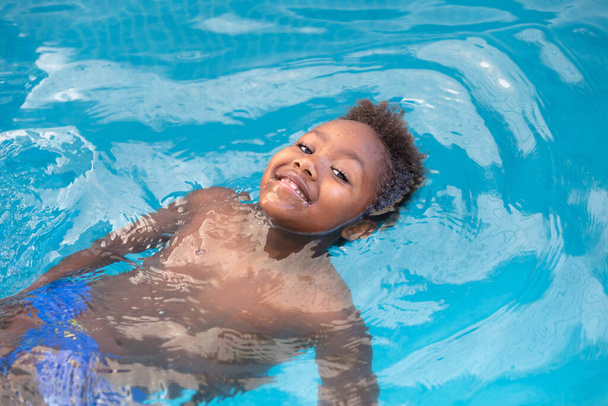 Little african child enjoying the summer in the pool  - Photo, Image