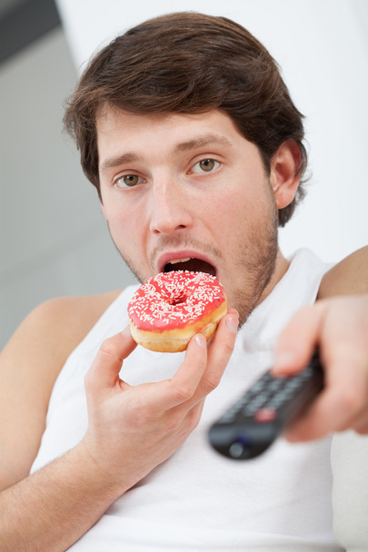 Man with donut - Фото, изображение