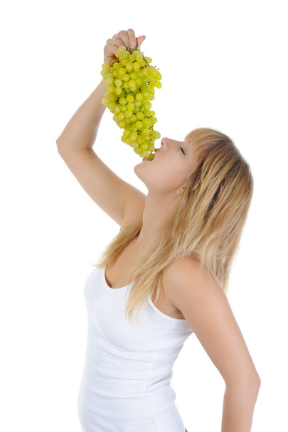 Blonde girl eating grapes - 写真・画像