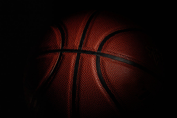 Professional sport equipment isolated on black studio background. Basketball ball. - Fotó, kép