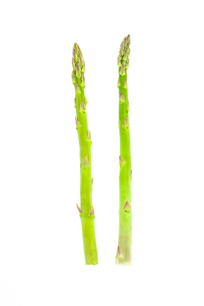 Fresh green asparagus isolated on white background. Creative healthy food concept. - Фото, зображення