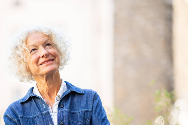 Kapalı portre gülümseyen yaşlı kadın yukarı bakıyor - Fotoğraf, Görsel