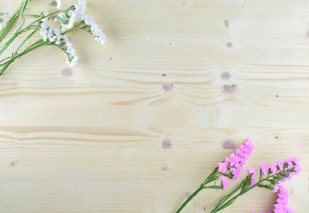 flores blancas y moradas sobre fondo de madera en plano aéreo con copyspace
 - Foto, Imagen