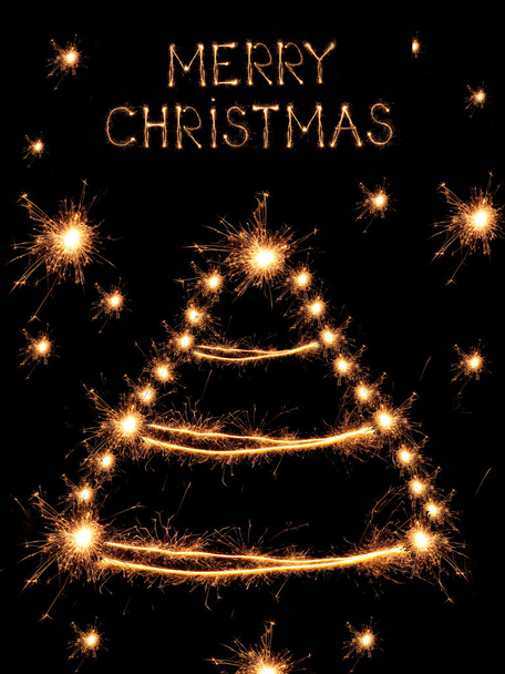 Christmas tree-shaped sparklers on black background - Zdjęcie, obraz