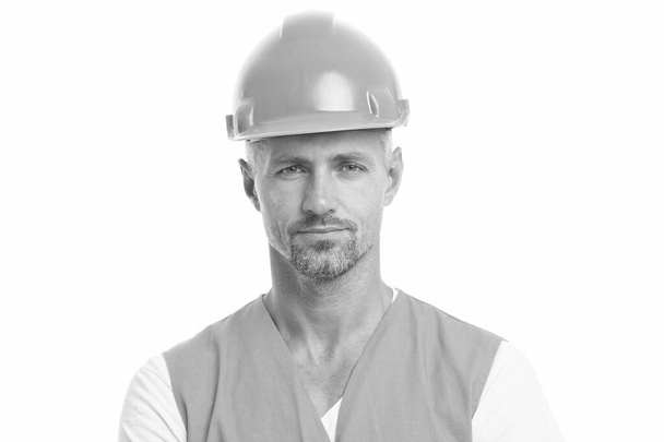 man in helmet. wear construction helmet on building site. Builders dressed in protective vest and helmet. Construction worker isolated on white. skilled technician in safety helmet. social work - Фото, изображение