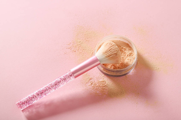 Brush and loose powder on a pink background. Place for text - Photo, Image