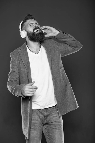 With song through life. Bearded man do vocal on song grey background. Hipster sing song playing in headphones. Emotional song singer. Music. Stay wild and free - Photo, Image