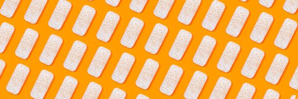 Pattern made of rice crackers or rice cakes on orange color background. - Fotografie, Obrázek
