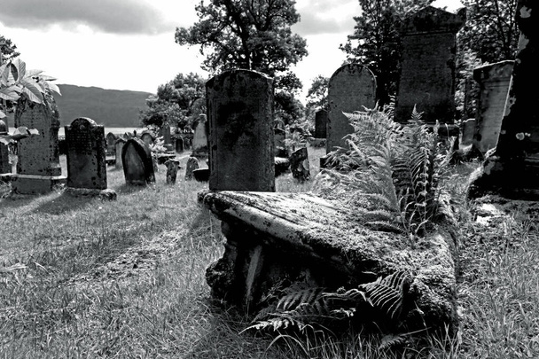 Old graves and gravestones in a cemetery in Scotland in black an white - Photo, Image