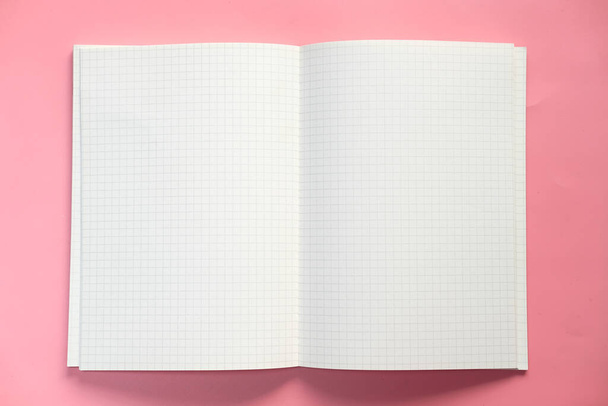 Top view of open notepad on pink background  - Zdjęcie, obraz