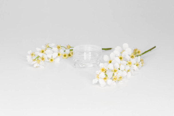 Elegant plastic cosmetic jar without branding on white background. Side view - Foto, imagen