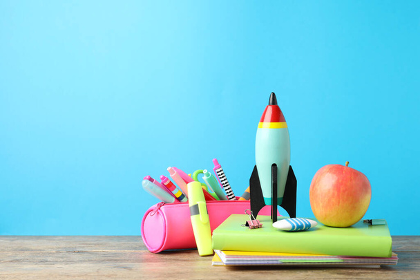 Bright toy rocket and school supplies on wooden table. Space for text - Φωτογραφία, εικόνα