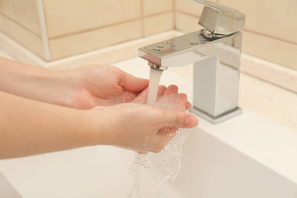 Woman washing hands with antiseptic soap in bathroom, closeup - Foto, Imagen