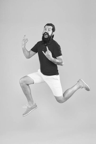 Full of strength and energy. Hipster dancing jumping. Feeling free. Running man yellow background. feel himself energetic. time to relax. its summer vacation - Foto, Bild