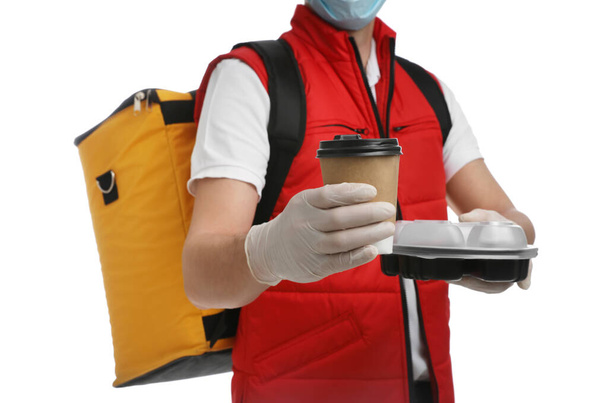 Courier in protective gloves with drink and food order on white background, closeup. Food delivery service during coronavirus quarantine - 写真・画像