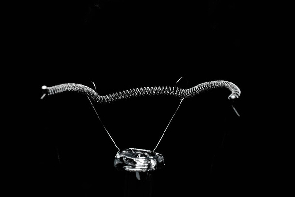 Close-up of the light bulb pole in the black background. - Valokuva, kuva