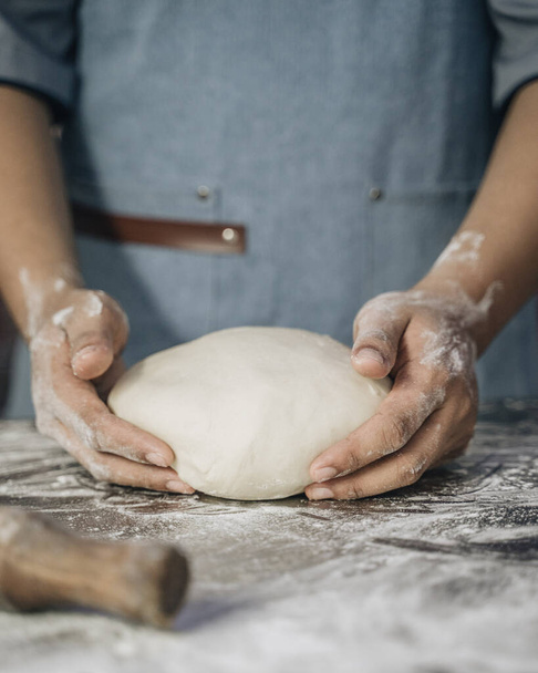 Man kneading dough for pastry on table - Φωτογραφία, εικόνα