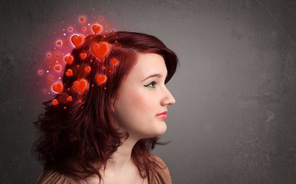 Young person thinking about love with red hearts - Φωτογραφία, εικόνα
