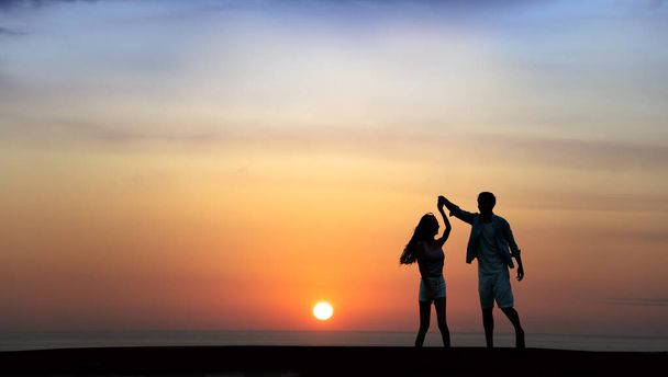 Happy Romantic young Couple dancing on the beach at sunset - Φωτογραφία, εικόνα