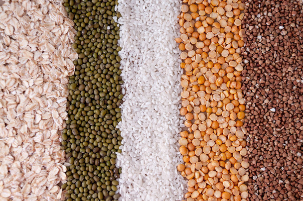Background in a strip of cereals oatmeal, mash, rice, peas and buckwheat on the table, top view - Fotografie, Obrázek
