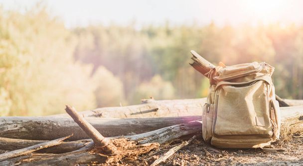 Active lifestyle and travel concept. Old canvas backpack on forest background - Fotoğraf, Görsel