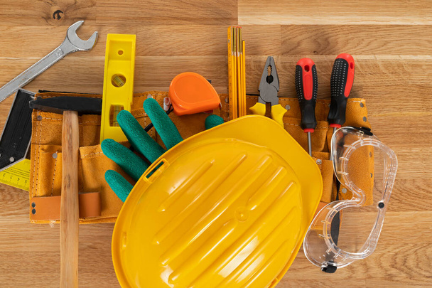 Picture of construction equipment and tools on wooden background, top view - Zdjęcie, obraz