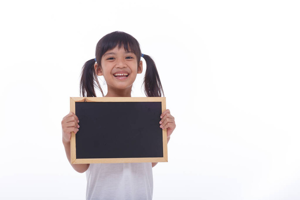 little Asian child show the black board on isolated background - Photo, image