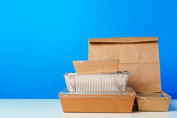 Assortment of various food delivery containers on table - Foto, afbeelding