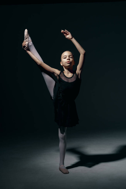 Delicate girl ballerina dancing in studio - Photo, image