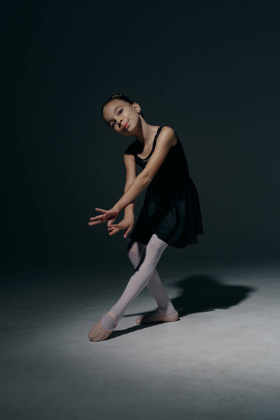 Delicate girl ballerina dancing in studio - Fotografie, Obrázek