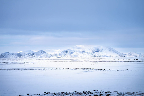 Snow covered mountains and Icelandic volcanic landscape in winter near Lake Myvatn, north east Iceland - Valokuva, kuva