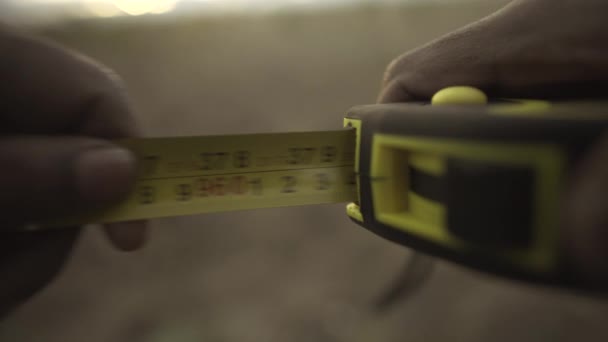 Measurement with a tape measure. steel tape measure extending then rewinding. - Footage, Video