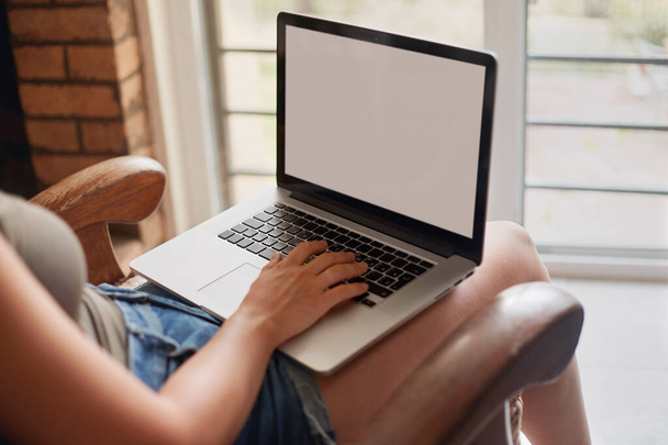 Woman working on a laptop online at home. Female using a laptop for searching web, browsing information. Distance learning. Freelancer  - Φωτογραφία, εικόνα
