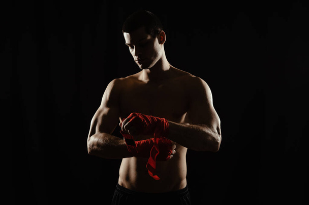 Portrait of a boxer bandaging hands - Photo, Image