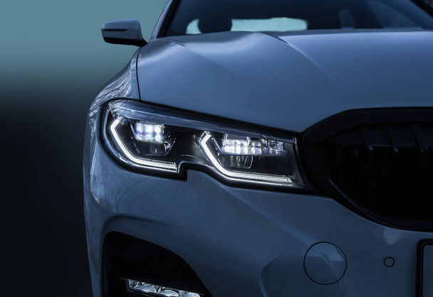 Glowing Headlight of a modern car close-up - Foto, afbeelding
