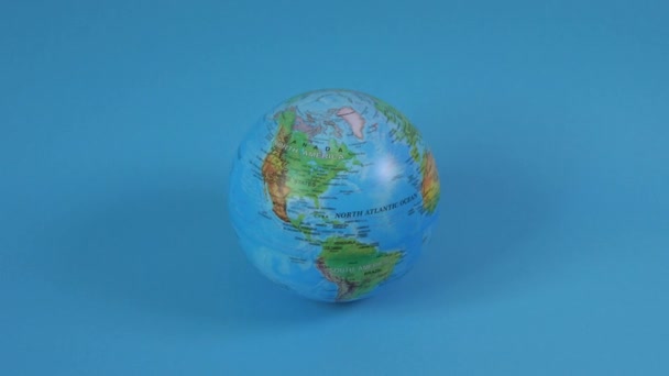 Planet Earth globe spinning on the blue background.  - Πλάνα, βίντεο