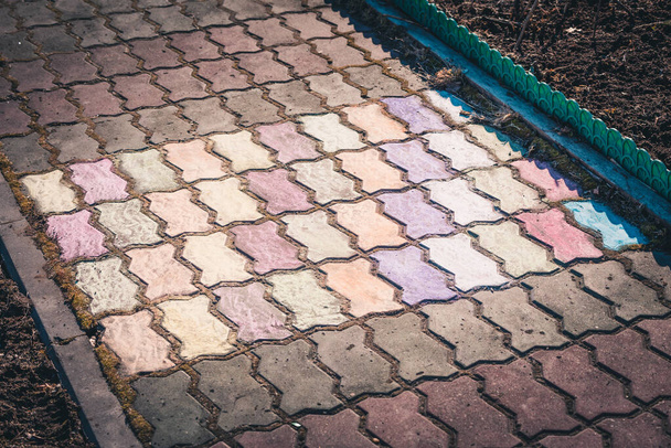 The paved stone walkway with colored crayons painted by children - Фото, изображение