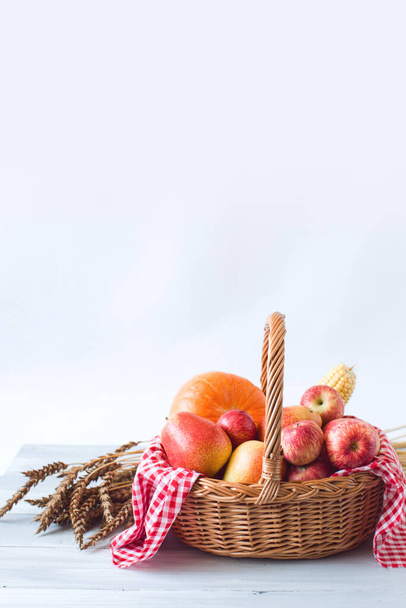 Still life of fresh fruit in a wicker basket and wheat. Farm products. - Foto, Imagen