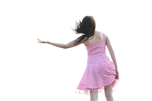 dancing brunette girl in short transparent pink dress  on her sexy legs isolated on white background - Valokuva, kuva
