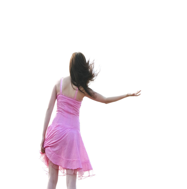 dancing brunette girl in short transparent pink dress  on her sexy legs isolated on white background - Foto, imagen